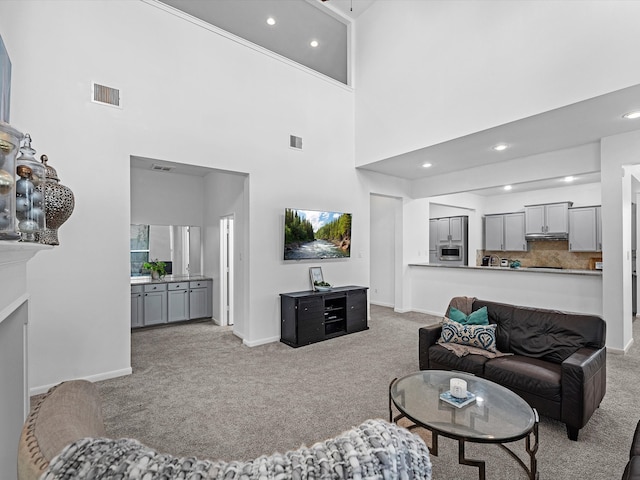 living room with light carpet and a high ceiling