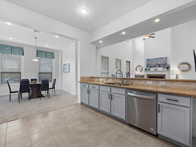 kitchen featuring light carpet, hanging light fixtures, dishwasher, gray cabinetry, and sink