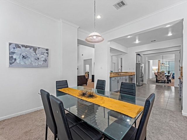 dining room featuring ornamental molding, carpet floors, and sink