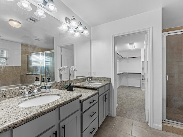 bathroom featuring vanity, an enclosed shower, and tile patterned floors