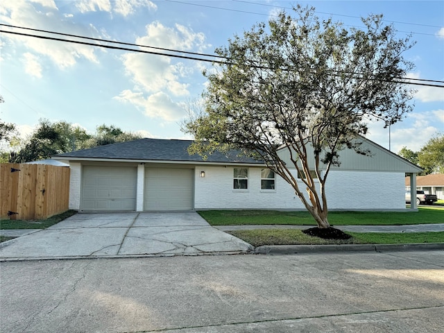 view of front of home with a garage and a front lawn