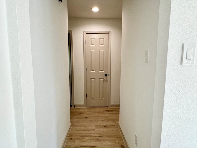 corridor with light hardwood / wood-style flooring