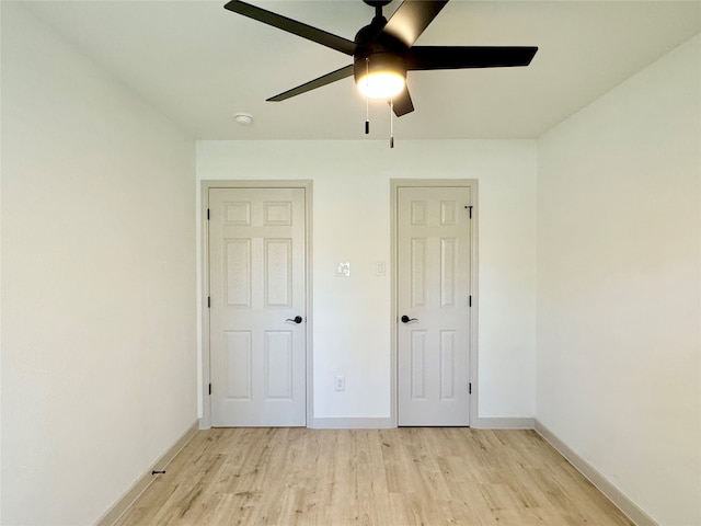 unfurnished bedroom featuring light wood-type flooring and ceiling fan