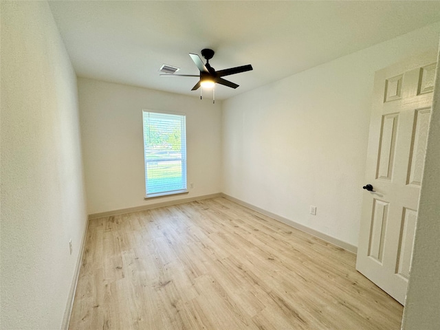 spare room featuring light hardwood / wood-style floors and ceiling fan