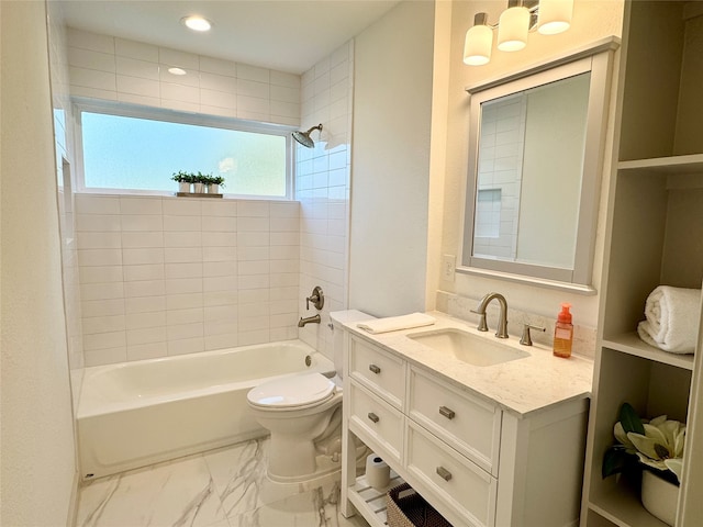 full bathroom featuring toilet, tiled shower / bath combo, and vanity