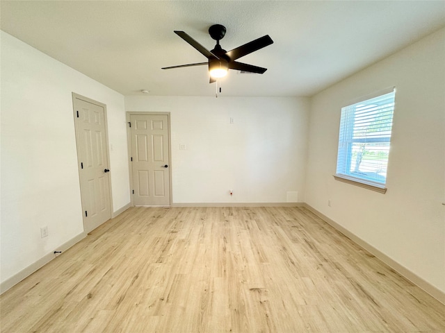 spare room featuring ceiling fan and light hardwood / wood-style flooring