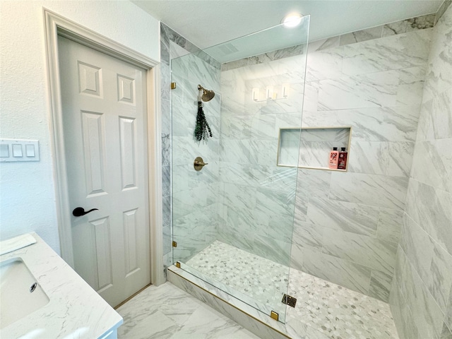 bathroom with vanity and tiled shower