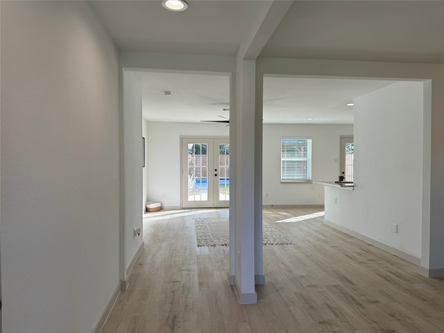 hall featuring french doors and light hardwood / wood-style flooring