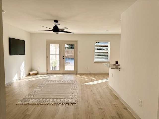 entryway featuring ceiling fan, french doors, and light hardwood / wood-style floors