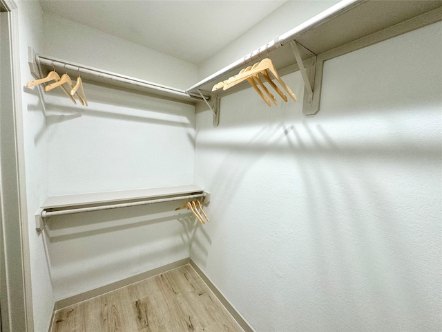 spacious closet with light hardwood / wood-style floors