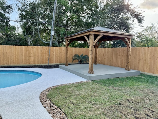 view of pool with a lawn, a deck, and a gazebo