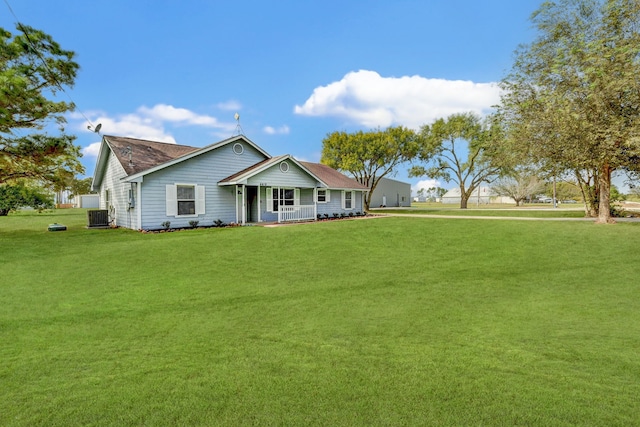 view of front of home with a front yard and central AC unit