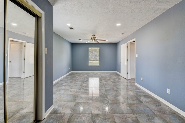 spare room featuring ceiling fan and a textured ceiling