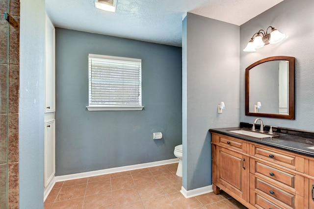 bathroom featuring vanity, a textured ceiling, toilet, and tile patterned floors