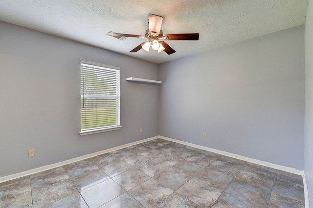 spare room with ceiling fan and a textured ceiling