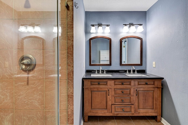 bathroom with vanity, tile patterned floors, and tiled shower