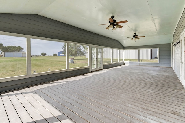 unfurnished sunroom featuring lofted ceiling and ceiling fan