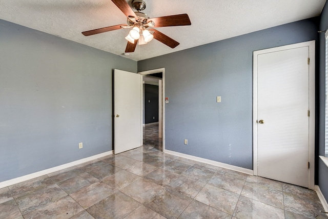 unfurnished bedroom with a textured ceiling and ceiling fan