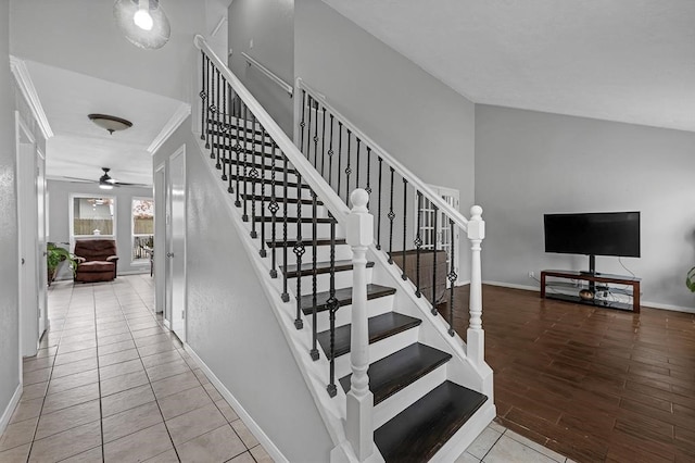 staircase featuring ceiling fan and tile patterned flooring