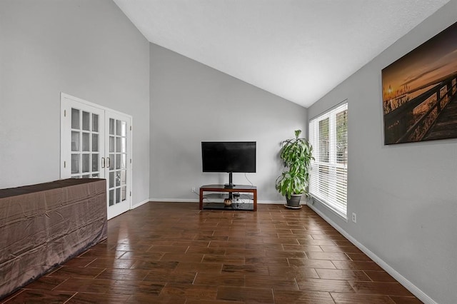 unfurnished living room with french doors and lofted ceiling