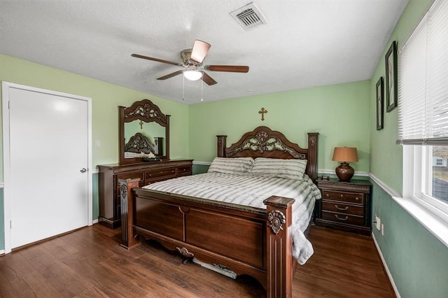 bedroom with ceiling fan and dark hardwood / wood-style floors