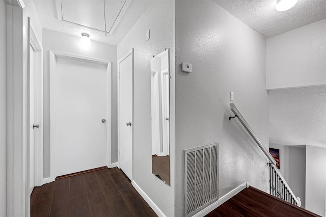 hall featuring a textured ceiling