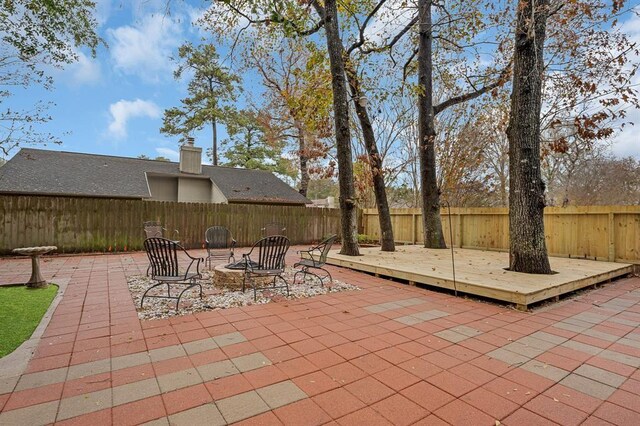 view of patio featuring a fire pit and a deck