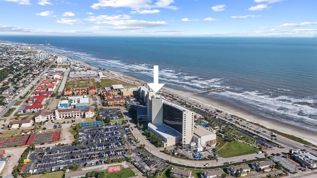 drone / aerial view featuring a water view and a beach view