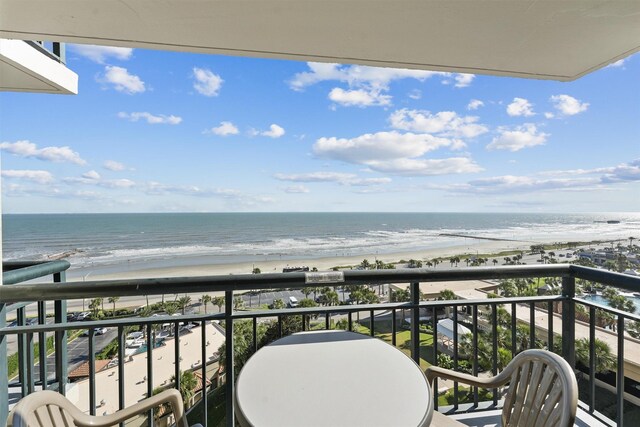 balcony with a water view and a beach view