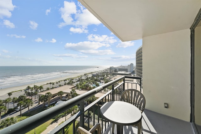 balcony with a water view and a beach view