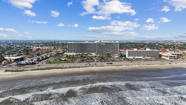 birds eye view of property with a water view and a view of the beach