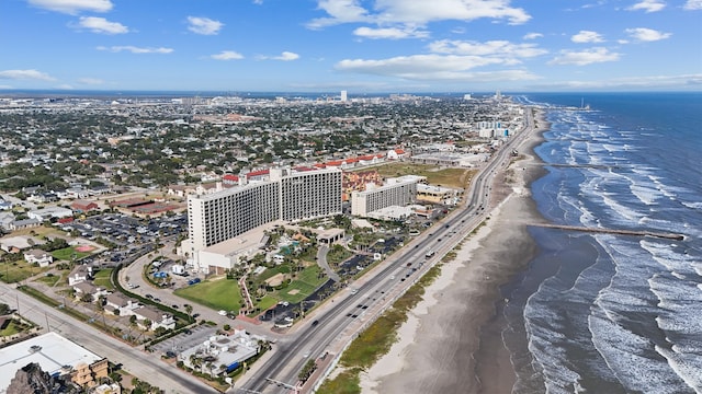 aerial view with a water view and a beach view