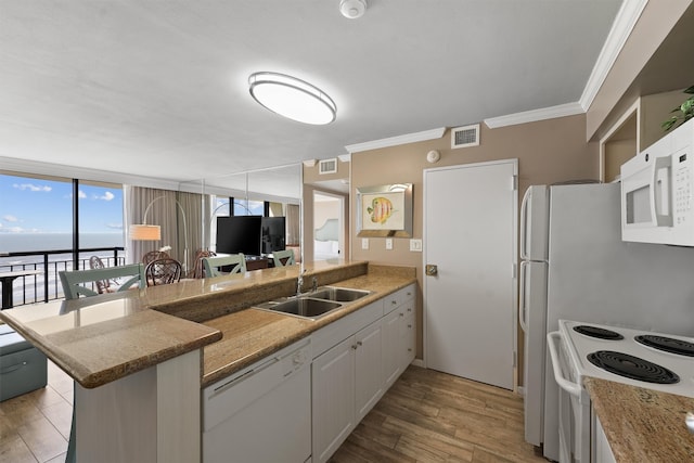 kitchen featuring white appliances, light hardwood / wood-style floors, kitchen peninsula, and white cabinets