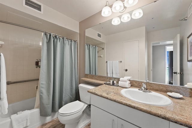 full bathroom featuring vanity, hardwood / wood-style floors, shower / bath combo with shower curtain, and toilet