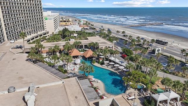 birds eye view of property featuring a water view and a beach view