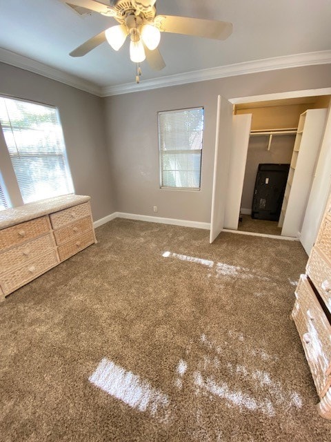 unfurnished bedroom featuring ornamental molding, carpet, and ceiling fan