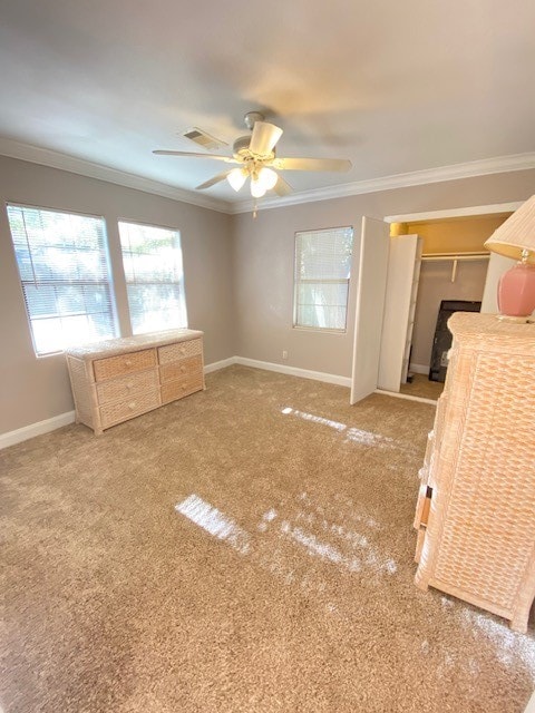 unfurnished bedroom with crown molding, a closet, carpet, and ceiling fan