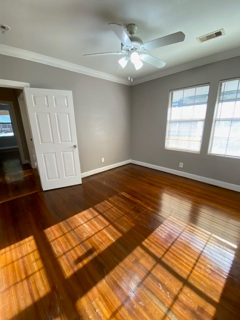 unfurnished room featuring crown molding and hardwood / wood-style flooring