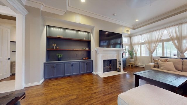 living room with crown molding, built in features, and dark hardwood / wood-style floors