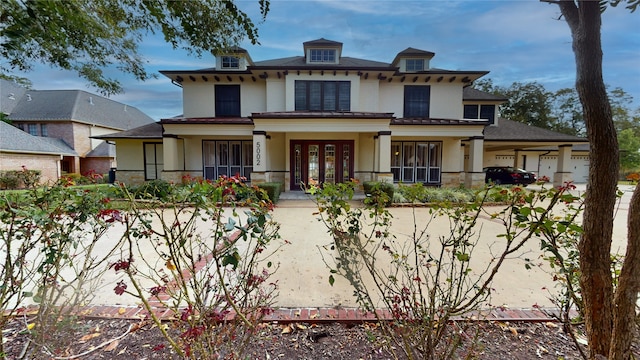 view of front facade featuring a porch and a garage