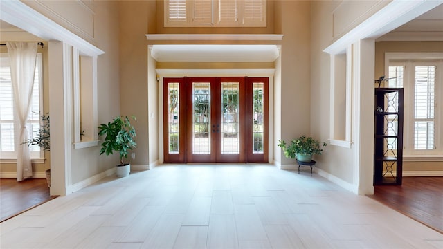 entrance foyer featuring crown molding and light wood-type flooring