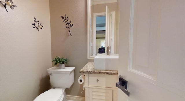 bathroom featuring toilet and vanity