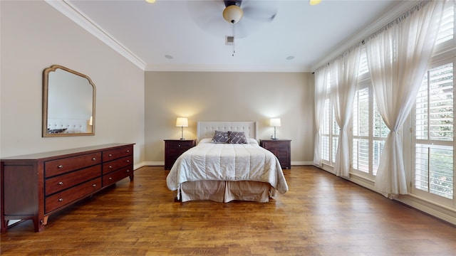 bedroom with dark wood-type flooring, ceiling fan, ornamental molding, and multiple windows