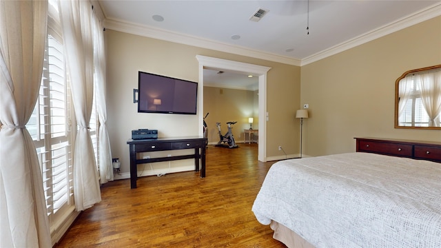 bedroom featuring crown molding, multiple windows, and dark hardwood / wood-style flooring