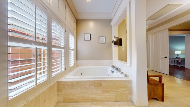 bathroom with ornamental molding, tiled tub, and tile patterned flooring