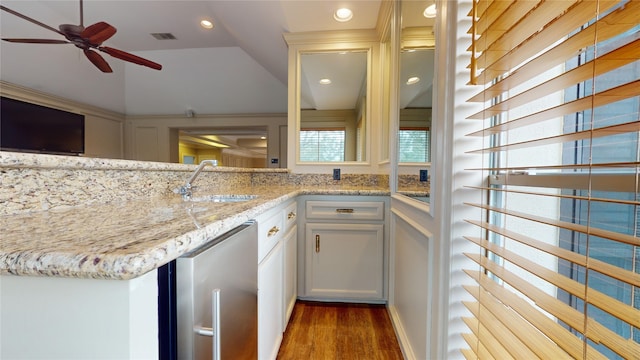 kitchen featuring white cabinets, light stone countertops, stainless steel dishwasher, dark hardwood / wood-style floors, and sink