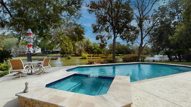 view of swimming pool featuring a patio and a water view