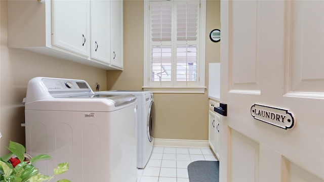 washroom with cabinets, light tile patterned flooring, and separate washer and dryer