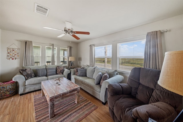 living room featuring light hardwood / wood-style floors and ceiling fan