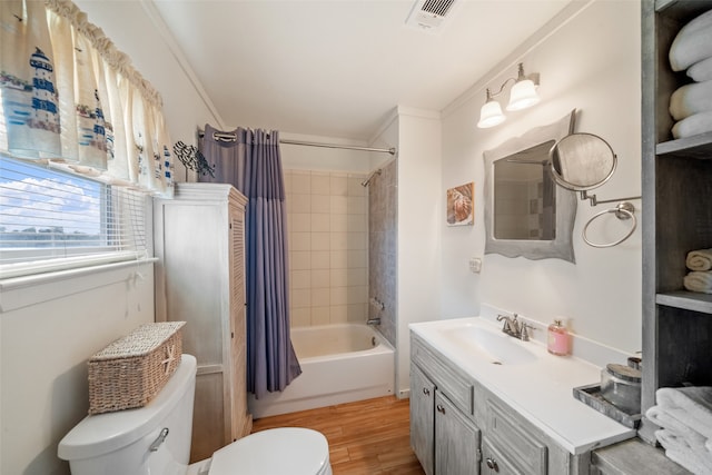 full bathroom with shower / tub combo, toilet, vanity, hardwood / wood-style flooring, and ornamental molding